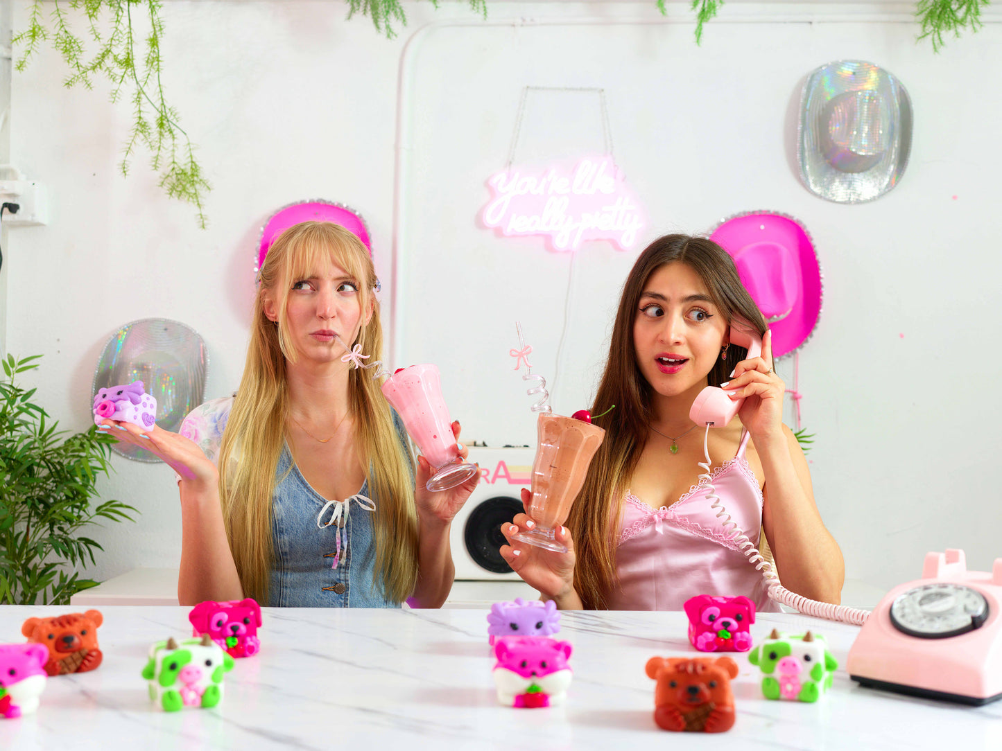 Erin and Anna along with Mushykinz taba squishies at a table