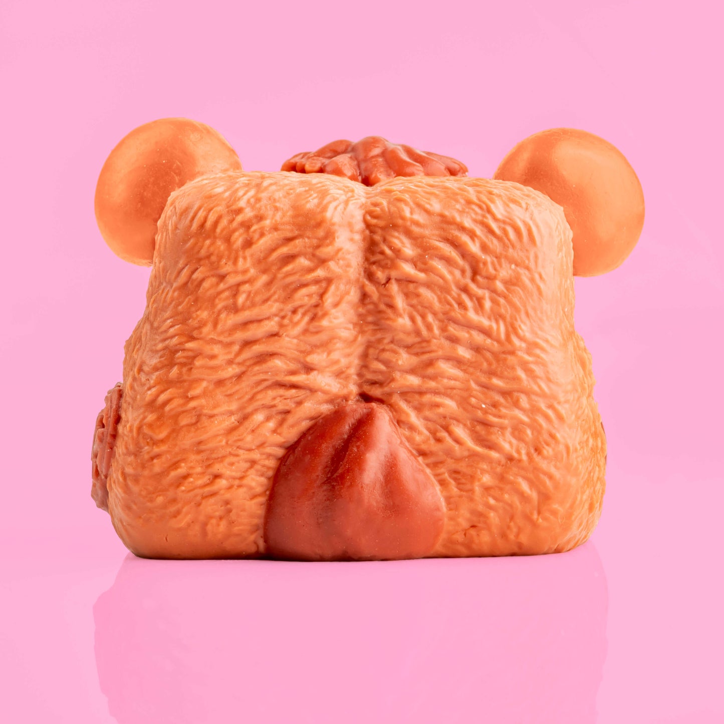 Button the Bear Mushykinz taba squishy back view on a pink background