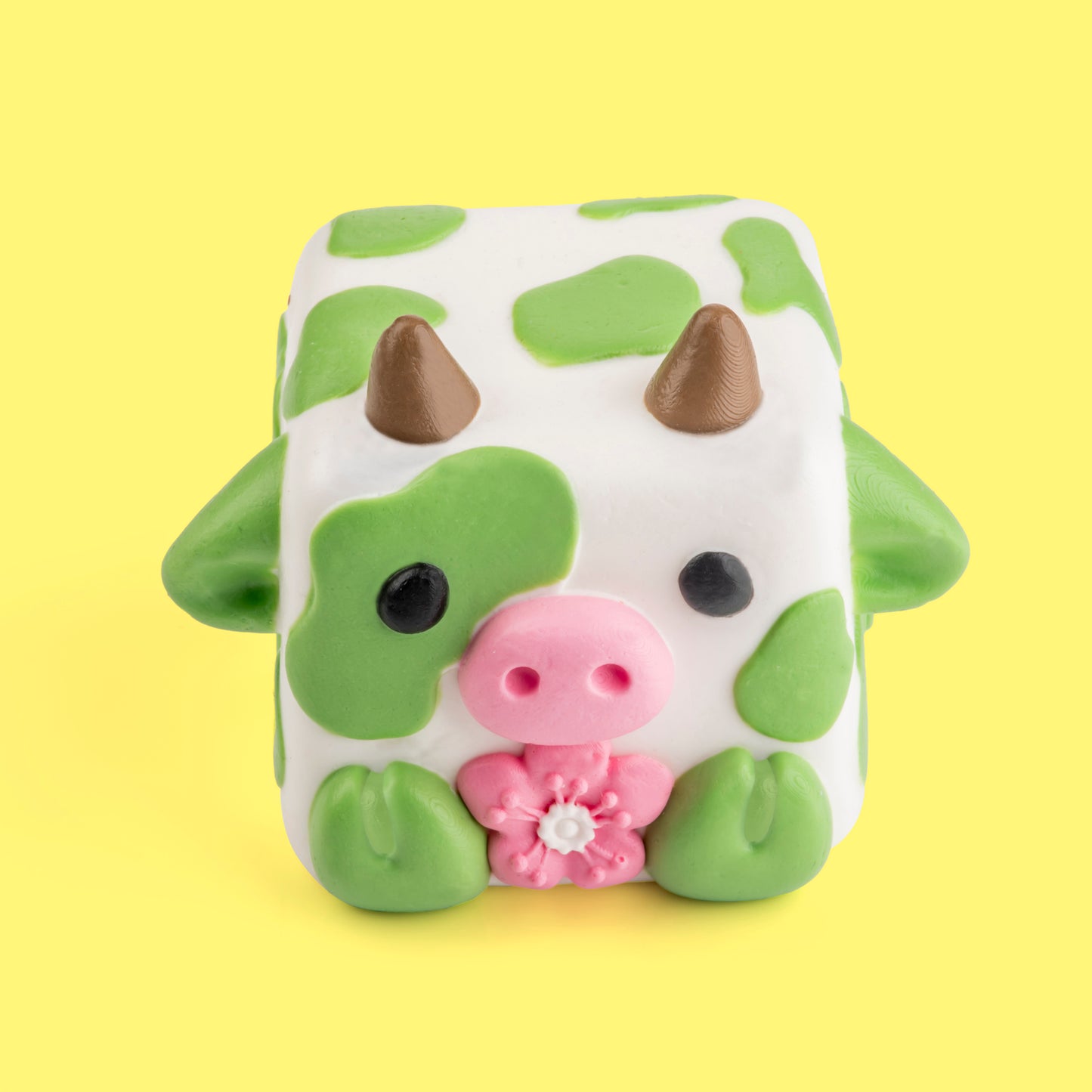 Chip the cow Mushykinz taba squishy top front view on a yellow background
