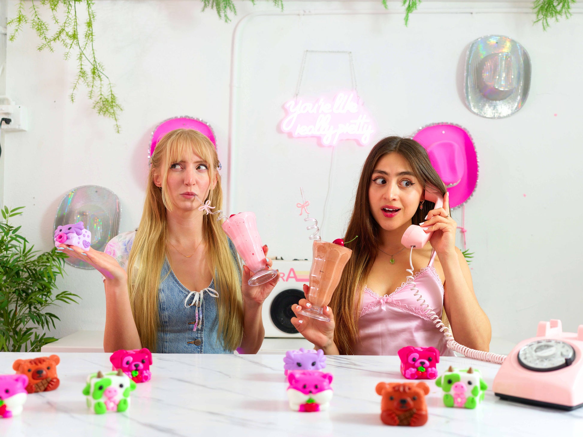 Erin and Anna along with Mushykinz taba squishies at a table 