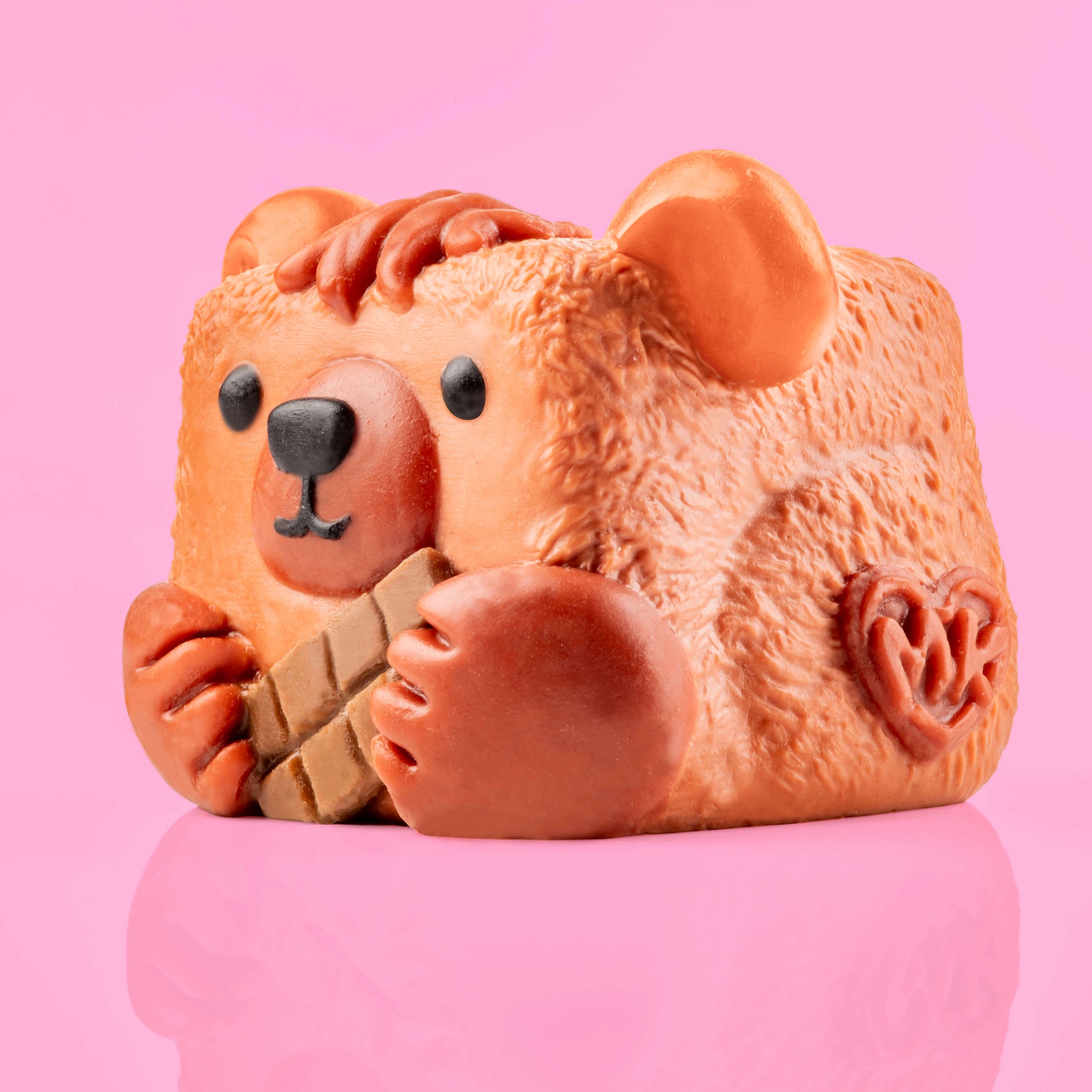 Button the Bear Mushykinz taba squishy left side view on a pink background