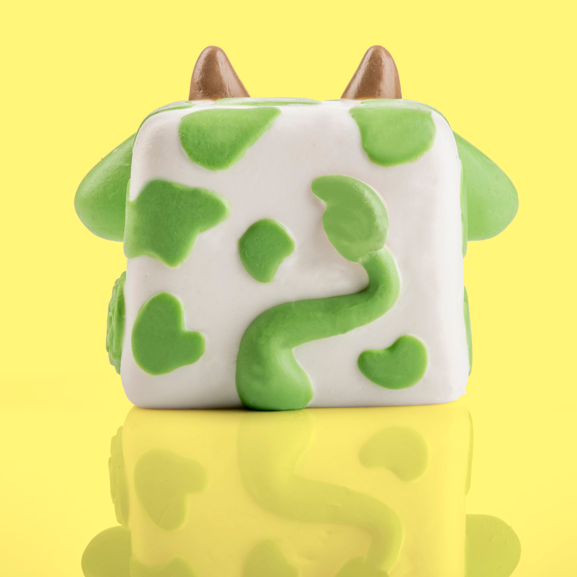 Chip the cow Mushykinz taba squishy back view on a yellow background