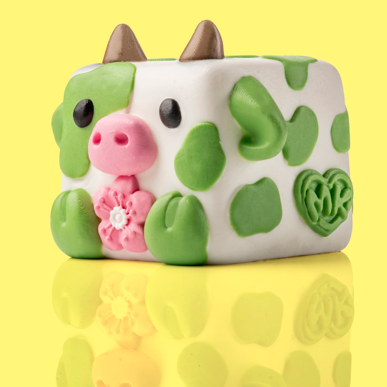 Chip the cow Mushykinz taba squishy left side view on a yellow background