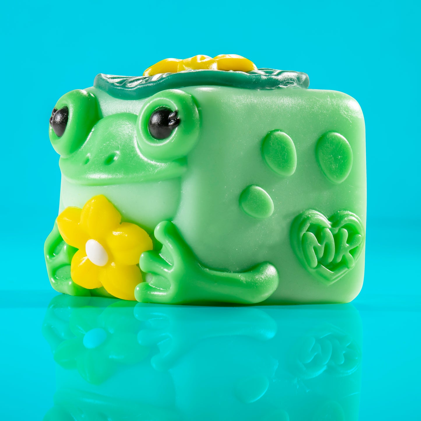 Lily the frog Mushykinz taba squishy left side view on a blue background